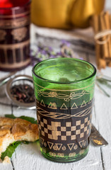 Arabic nana mint tea in traditional glass with mint