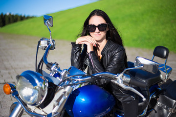 Fototapeta na wymiar portrait of beautiful girl sitting on retro motorcycle