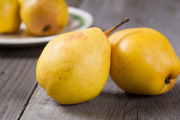 Fresh ripe organic yello pears on rustic wooden table, natural background, diet food.