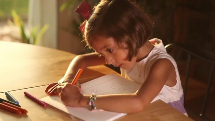 Little girl writing and drawing Doing homeworks adorable dedicated studying child cute young pupil
