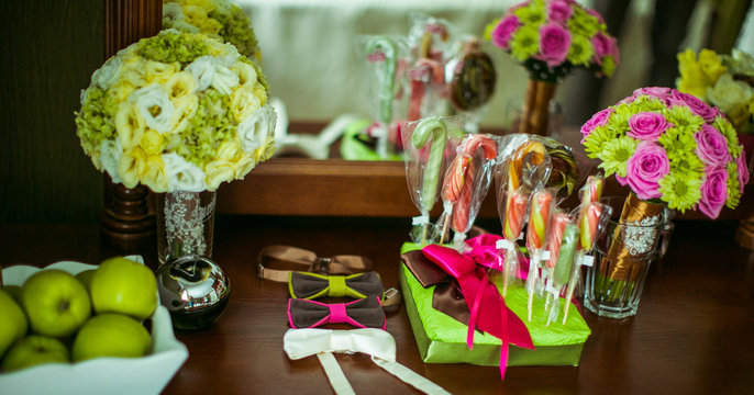 Sweets and apples stand on the dressing table before wedding acc