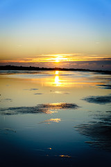 Sunrise reflecting on the beach