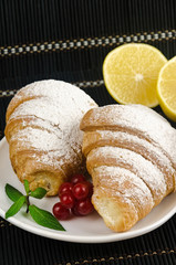 fresh crispy croissants with sprinkles on plate mint