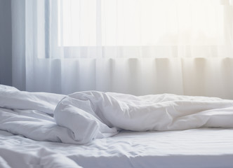 White themed bed sheets bedroom interior.