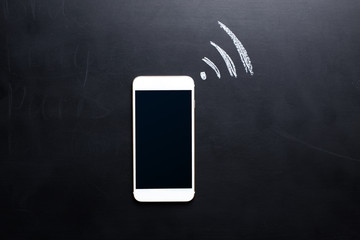 Wireless Symbol Drawn on a Blackboard near smartphone