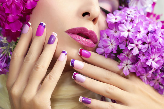 The French pink lilac manicure and makeup with phloxes on the girl.