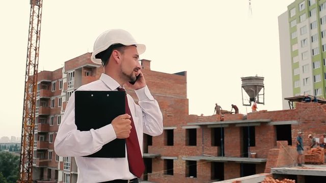 The foreman are talk phone at construction site