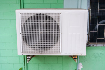 Old air compressor with rust on the wall outdoor