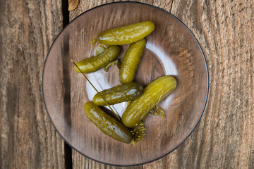 six polish picled cucambers on the glass plate