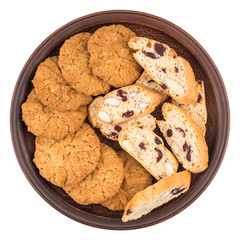 Cookies with raisins in a ceramic plate. Isolated on white backg