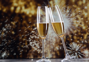 toasting with champagne glasses against holiday lights