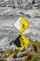 double rockfall warning signs at glacier franz josef in new zealand