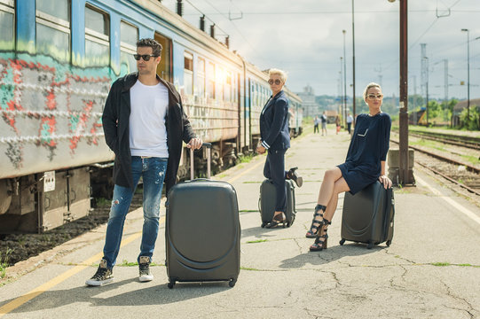 Business people with suitcase posing on the railway station