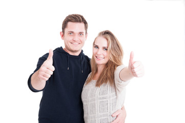 Couple posing smiling and showing thumb up