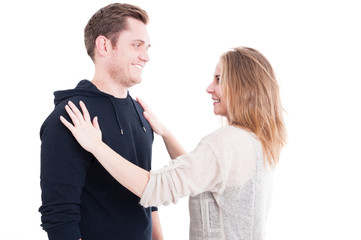 Pretty woman fixing man's autumn casual sweater