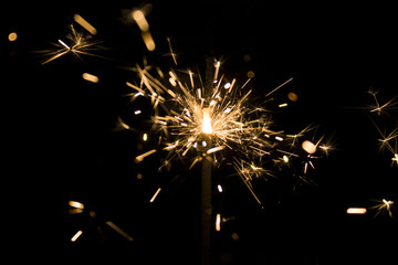 Fototapeta premium Burning sparkler isolated on black background