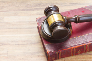 Wooden Law Gavel on legal book on wooden desktop