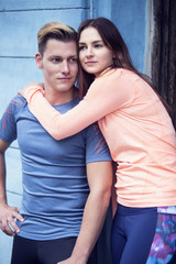 portrait of sporty young couple hugging