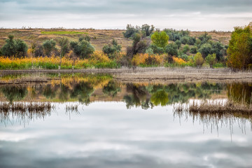 Autumn landscape on the lake in cloudy weather