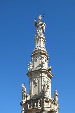 Statue of Saint Oronzo in Ostuni, Italy. Saint Oronzo is credited with protecting Ostuni from an 18th century famine. The statue stands atop a spire erected in 1771.
