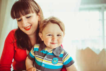 Smiling mom and her cute baby boy