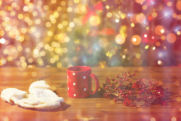 tea cup with mittens and christmas decoration