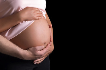 Man and pregnant woman caressing her belly