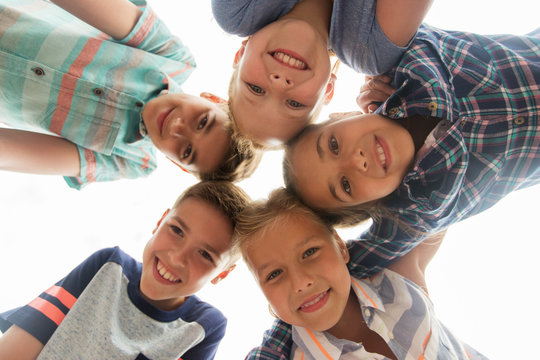 group of happy children faces in circle