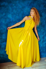 lady in a yellow dress is the model for the photographer