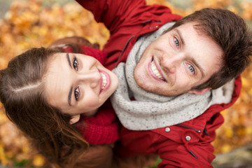 close up of happy couple taking selfie at autumn