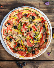Top view of italian pizza served on wooden table