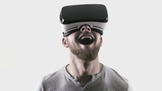 Emotion smile happy man wearing virtual reality goggles. VR headset. look up
