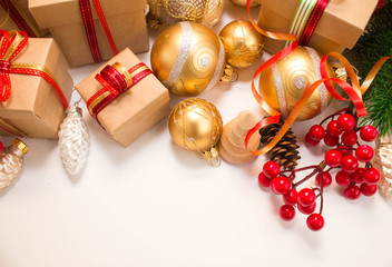 Christmas or New Year background: fur-tree, branches, gifts, colored glass balls, decoration and cones on a white background