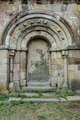 Fototapeta na wymiar dazzled door of the Romanesque church of Santa Eulalia in the Brañosera town in Palencia, Castile and León, Spain