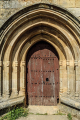 sight of the door of the Romanesque church of Santa Juliana in the Corvio town in Palencia, Castile and León, Spain