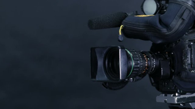 Studio broadcasting camera isolated on black background. 4K.