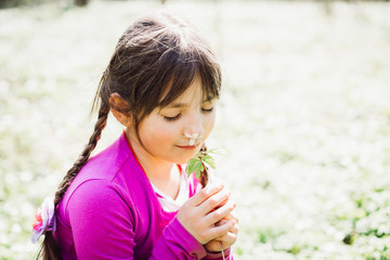 Child girl with little flower