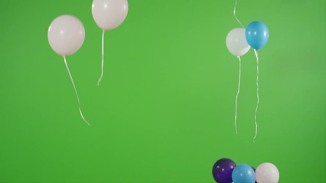Many helium balloons rise up on green screen. Shot on RED EPIC Cinema Camera.