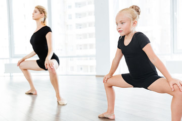 Obraz premium Beautiful little dancer and her dancing teacher in a studio