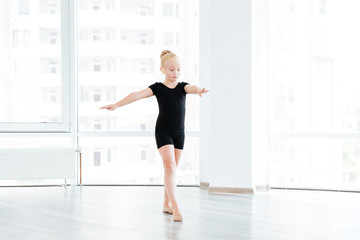 Fototapeta na wymiar Young little ballet dancing student at a class