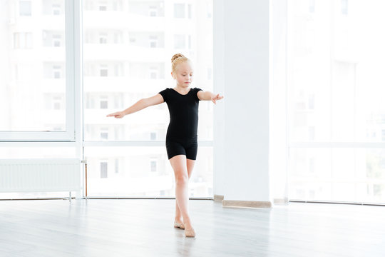 Young little ballet dancing student at a class