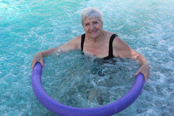 senior woman swimming in a pool