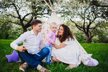 Beautiful young family in the nature