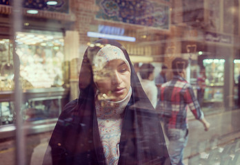 Beautiful Muslim woman spending time on traditional Iranian baza