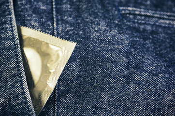condom in the pocket of mans trousers close-up horizontal