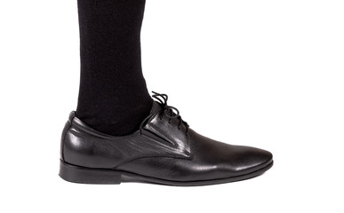 men's leg with a black patent-leather shoes