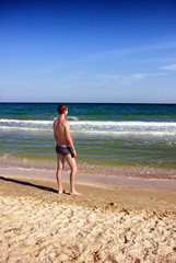 man is standing on the sea shore