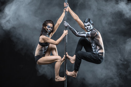 Posing Of Pole Dance Couple In Dark Studio