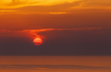 sunset behind clouds in Oia on Santorini