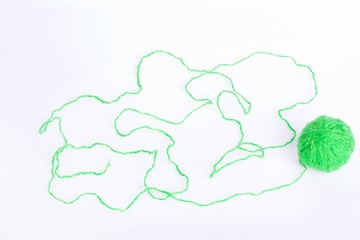 green thread wound on a white background